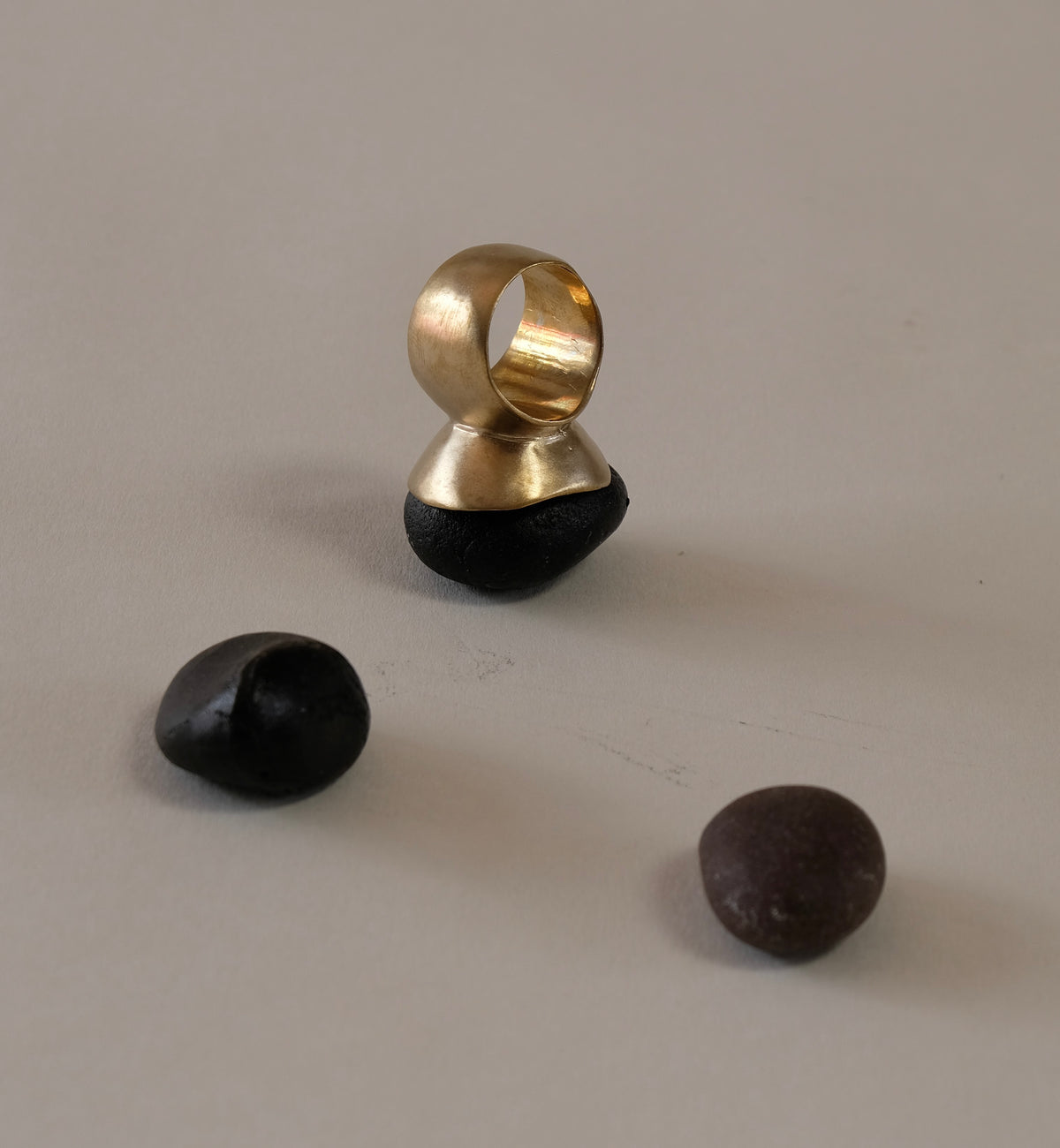 sculptural brass ring hand made to hold a pebble