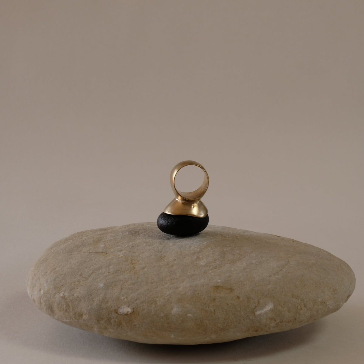 Sculptural contemporary brass ring, bold  ring with a concave dome shape on the top. Style don a large grey pebble