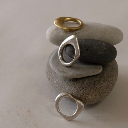 Three stacking rings of natural organic hand carved shapes, silver and golden brass