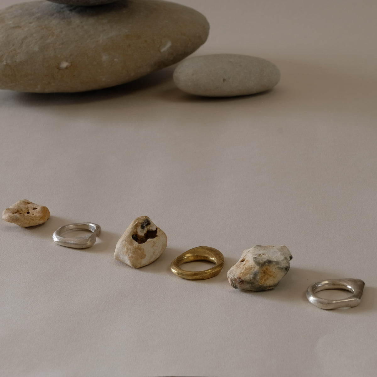 three stacking rings in brass and silver inspired by hag stones