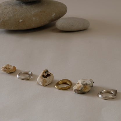 three stacking rings in brass and silver inspired by hag stones