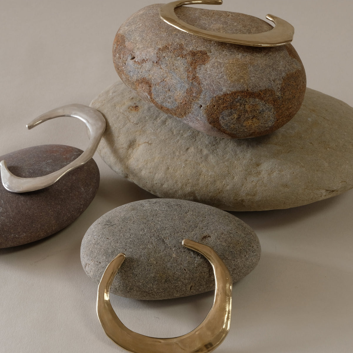 Minimalist contemporary hand made bangles in golden brass and silver. 