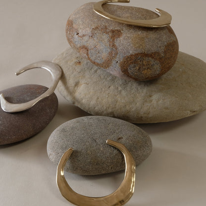 Minimalist contemporary hand made bangles in golden brass and silver. 