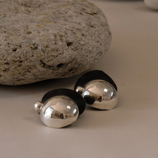 A pair of silver dome stud earrings. hand formed to look like pebbles. 