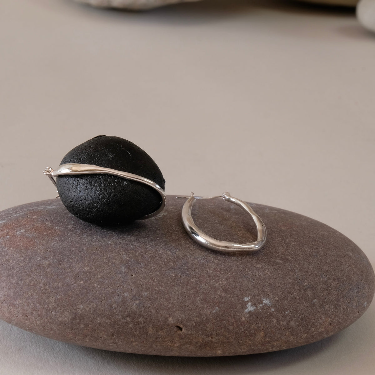 Slim Silver organic shaped long hoop earring with creole fittings and high polish.  hand made